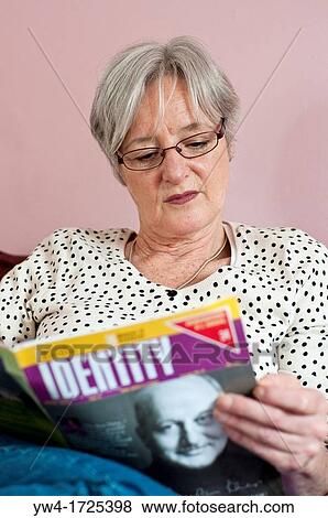 Portrait of middle aged woman reading the magazine called Identity View Large Photo Image Stock Photo - Portrait of middle aged woman reading the magazine called Identity. Fotosearch