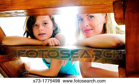 Portrait Of Mother And Child Relaxing inside home View Large Photo Image Stock Photo - Portrait Of Mother And Child Relaxing inside home. Fotosearch