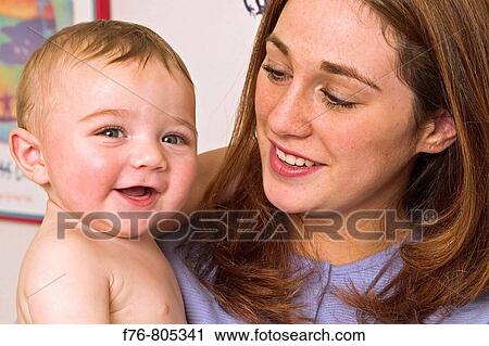 Portrait of mother, holding her infant View Large Photo Image Stock Image - Portrait of mother, holding her infant. Fotosearch
