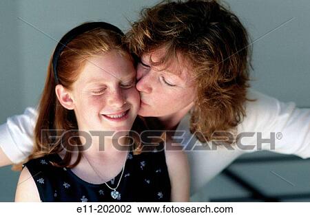 Portrait of mother kissing daughter View Large Photo Image Stock Image - Portrait of mother kissing daughter. Fotosearch