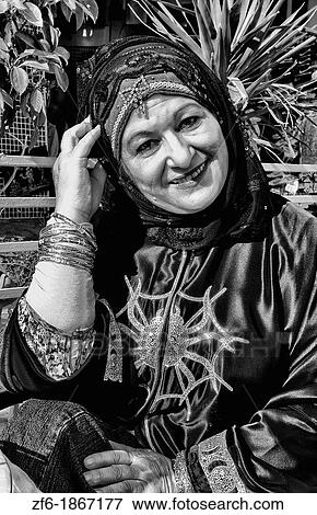 Portrait of Muslim woman with spider dress in Medina shopping area of Sousse Tunisa Africa View Large Photo Image Stock Photo - Portrait of Muslim woman with spider dress in Medina shopping area of Sousse Tunisa Africa. Fotosearch
