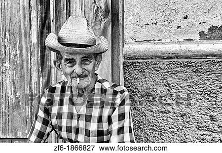 Portrait of old man cowboy with hat in front of yellow wall in Trinidad Cuba View Large Photo Image Stock Photo - Portrait of old man cowboy with hat in front of yellow wall in Trinidad Cuba. Fotosearch