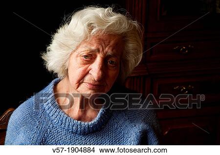 Portrait of old woman at home, looking at the camera. Close view. View Large Photo Image Picture - Portrait of old woman at home, looking at the camera. Close view.. Fotosearch