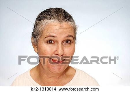 Picture - Portrait of older woman with self conscious grin. Fotosearch