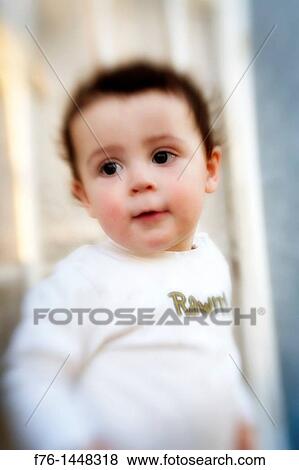 Portrait of one year old boy with apprehensive look and with blur intentionally introduced with a Lensbaby View Large Photo Image Stock Photo - Portrait of one year old boy with apprehensive look and with blur intentionally introduced with a Lensbaby. Fotosearch