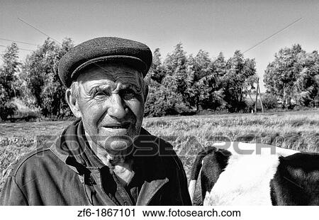Portrait of poor farming man with his cow in rural farms between Kiev and Lviv Ukraine View Large Photo Image Stock Image - Portrait of poor farming man with his cow in rural farms between Kiev and Lviv Ukraine. Fotosearch