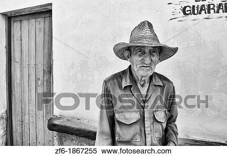 Stock Photography - Portrait of poor man with straw hat in small town of Australia Cuba. Fotosearch