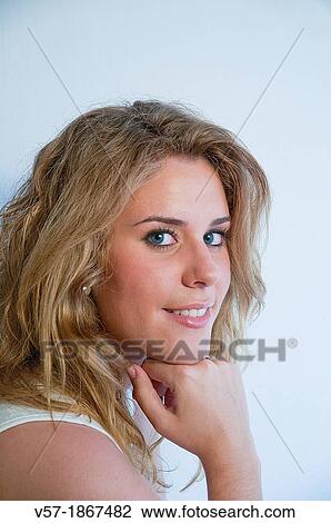 Portrait of pretty young woman smiling and looking at the camera. Close view. View Large Photo Image Stock Image - Portrait of pretty young woman smiling and looking at the camera. Close view.. Fotosearch