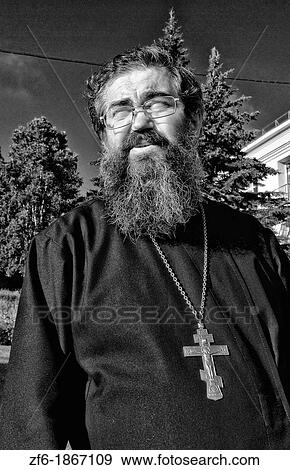 Portrait of Priest in Russian Orthodox Church inBeautiful old wooden houses with shutters in famous Listvyanka near Irkutsk in Siberia Russia View Large Photo Image Stock Photo - Portrait of Priest in Russian Orthodox Church inBeautiful old wooden houses with shutters in famous Listvyanka near Irkutsk in Siberia Russia. Fotosearch