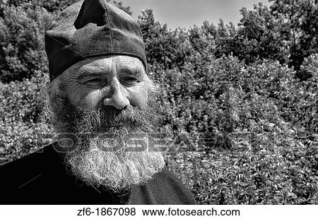 Portrait of Russian Orthodox priest in red hat in country of Lviv Ukraine View Large Photo Image Stock Photo - Portrait of Russian Orthodox priest in red hat in country of Lviv Ukraine. Fotosearch