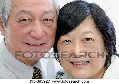 Stock Photo - Portrait of senior asian couple in business attire. Fotosearch