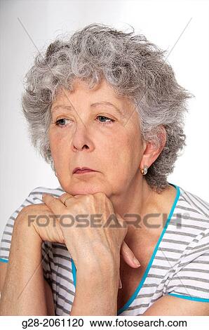 Portrait of Senior woman thoughtful, resting her chin on her hands, looking tired, depressed or sad View Large Photo Image Stock Image - Portrait of Senior woman thoughtful, resting her chin on her hands, looking tired, depressed or sad. Fotosearch