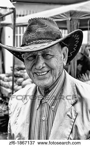 Stock Photo - Portrait of smiling local man in Central Market with fruits and vegetables in Pavas section of San Jose in Costa Rica Central America. Fotosearch