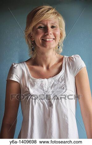 Portrait of smiling young woman in romantic white dress View Large Photo Image Stock Photo - Portrait of smiling young woman in romantic white dress. Fotosearch