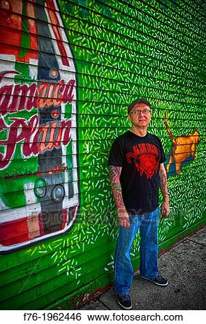 Portrait of tatoo artist against painted wall in Jamaica Plain, Massachusetts, USA View Large Photo Image Stock Photograph - Portrait of tatoo artist against painted wall in Jamaica Plain, Massachusetts, USA. Fotosearch