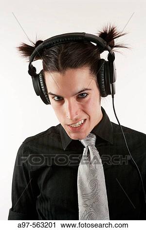 Stock Image - Portrait of teen boy wearing headset. Angry sneer on face.. Fotosearch