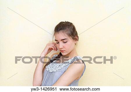 Stock Image - Portrait of teenage girl indoors with braid. Fotosearch