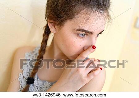 Stock Photograph - Portrait of teenage girl indoors with braid. Fotosearch