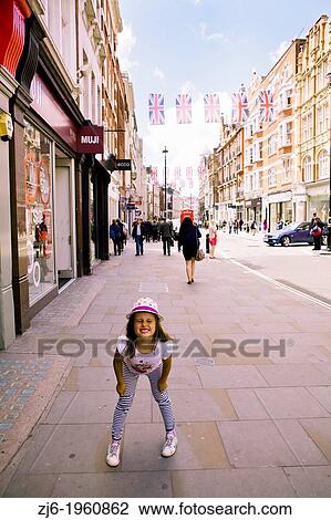 Portrait of the girl joking on the street of London. Oxford Street. View Large Photo Image Stock Image - Portrait of the girl joking on the street of London. Oxford Street.. Fotosearch