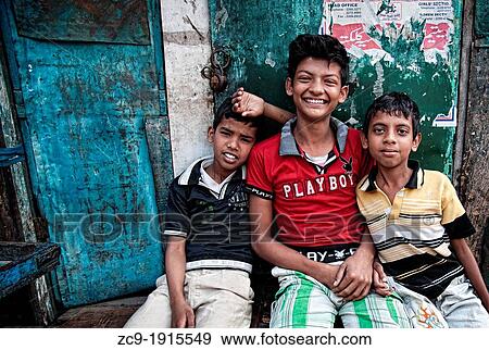 Portrait of three children sitting in the streets of Calcutta, Kokata, West Bengal, India View Large Photo Image Stock Photo - Portrait of three children sitting in the streets of Calcutta, Kokata, West Bengal, India. Fotosearch
