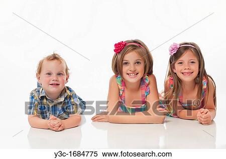 Stock Photography - Portrait of three happy children. Fotosearch