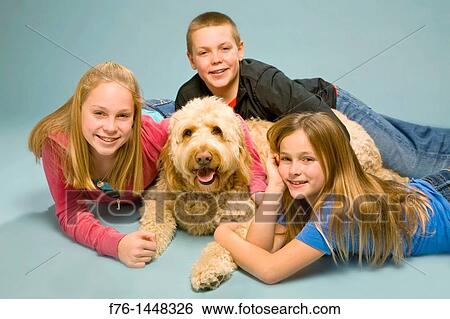 Portrait of three siblings with their golden retriever - poodle mix dog, MR 081210 View Large Photo Image Stock Photograph - Portrait of three siblings with their golden retriever - poodle mix dog, MR 081210. Fotosearch