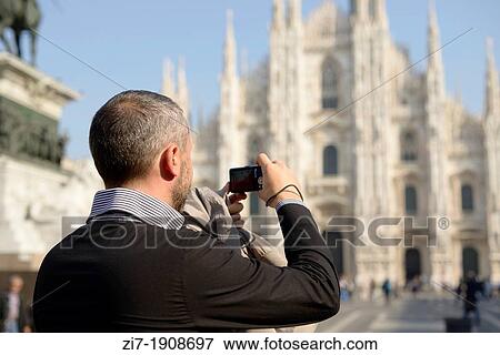 portrait of tourist man taking photos at Cathedral in city center, shot in bright light View Large Photo Image Stock Photo - portrait of tourist man taking photos at Cathedral in city center, shot in bright light. Fotosearch