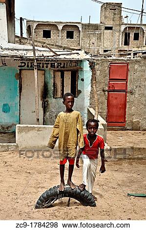 Portrait of two children on a buried tyre Saint Louis, Senegal View Large Photo Image Stock Photo - Portrait of two children on a buried tyre Saint Louis, Senegal. Fotosearch