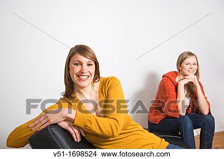 Portrait of two girlsfriends at the sofa View Large Photo Image Picture - Portrait of two girlsfriends at the sofa. Fotosearch