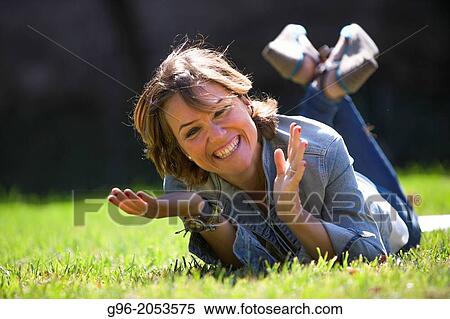 Portrait of woman in a park smiling. View Large Photo Image Stock Photography - Portrait of woman in a park smiling.. Fotosearch