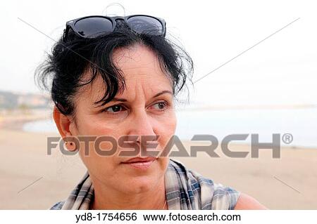 Stock Photograph - Portrait of woman on the Malagueta beach, Malaga, Andalucia, Spain. Fotosearch