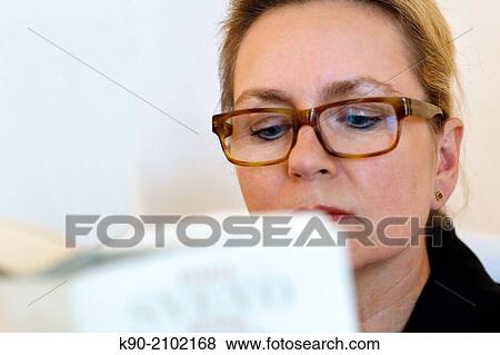 Stock Photo - Portrait of woman reading a book, Hamburg, Germany, Europe.. Fotosearch