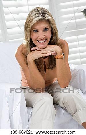Portrait of woman sitting on a chair View Large Photo Image Stock Photography - Portrait of woman sitting on a chair. Fotosearch