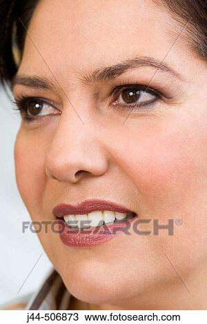Stock Image - Portrait of woman smiling. Fotosearch