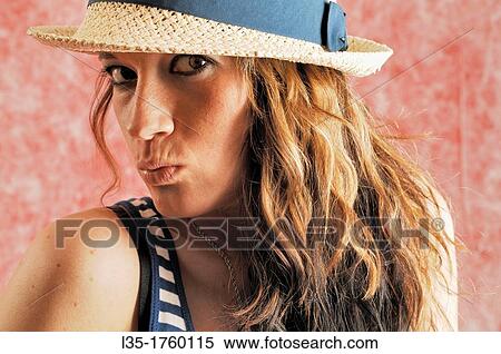 Stock Photography - Portrait of woman wearing a hat. Fotosearch