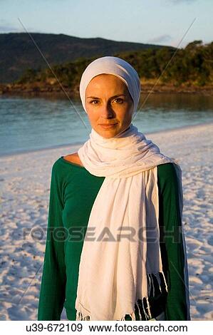 Portrait of woman wearing a headscarf. Whitehaven Beach, Australia. View Large Photo Image Stock Photo - Portrait of woman wearing a headscarf. Whitehaven Beach, Australia.. Fotosearch