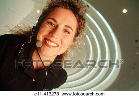 Portrait of woman wearing phone headset in office lobby View Large Photo Image Stock Photo - Portrait of woman wearing phone headset in office lobby. Fotosearch