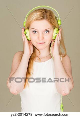 Portrait of young blond female teenager listening to music. View Large Photo Image Stock Photo - Portrait of young blond female teenager listening to music.. Fotosearch