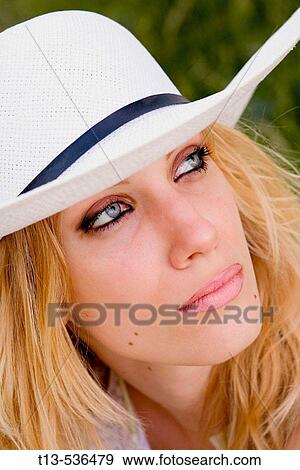 Portrait of young blond woman with white Summer hat View Large Photo Image Stock Photo - Portrait of young blond woman with white Summer hat. Fotosearch