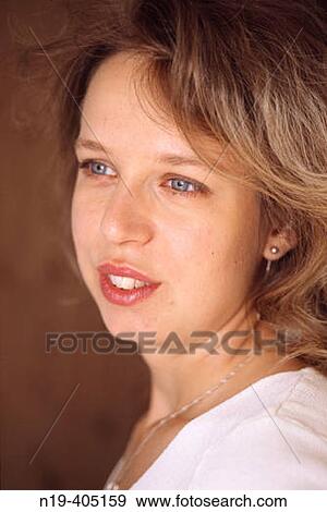 Stock Photo - Portrait of young blonde woman in white top.. Fotosearch