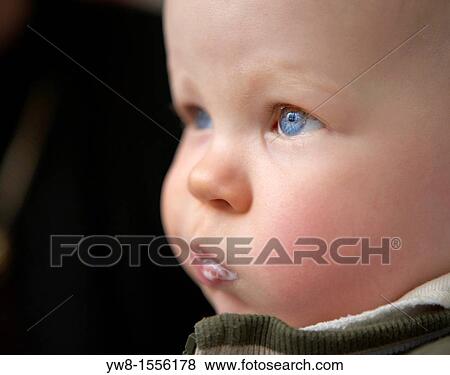 Stock Photo - Portrait of young boy with milk in his mouth. Fotosearch