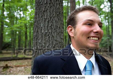 Portrait of young businessman in forest View Large Photo Image Stock Image - Portrait of young businessman in forest. Fotosearch