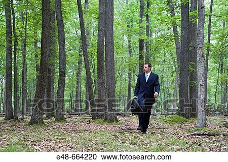 Portrait of young businessman in forest with briefcase View Large Photo Image Stock Image - Portrait of young businessman in forest with briefcase. Fotosearch