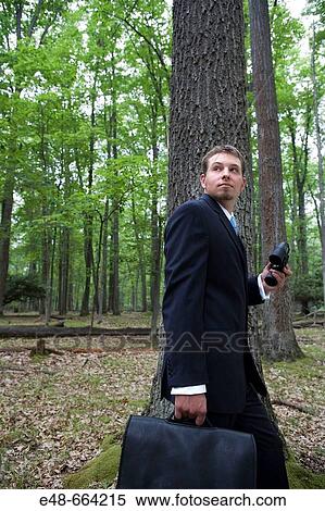 Portrait of young businessman in forest with binoculars View Large Photo Image Stock Photography - Portrait of young businessman in forest with binoculars. Fotosearch