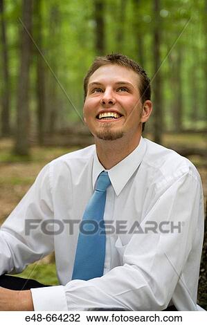 Portrait of young businessman sitting in forest View Large Photo Image Stock Image - Portrait of young businessman sitting in forest. Fotosearch