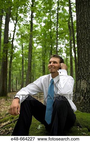 Portrait of young businessman sitting in forest View Large Photo Image Stock Photo - Portrait of young businessman sitting in forest. Fotosearch