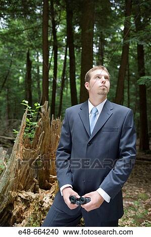 Portrait of young businessman standing in forest View Large Photo Image Stock Image - Portrait of young businessman standing in forest. Fotosearch