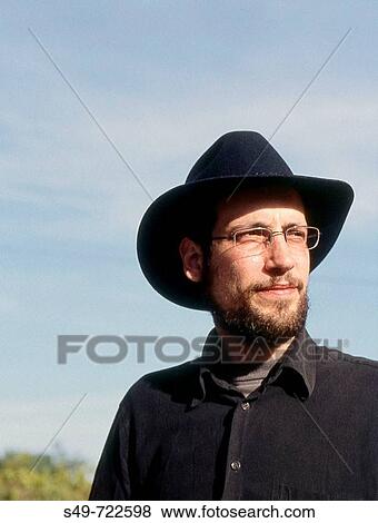 Stock Photo - Portrait of young front with a hat.. Fotosearch