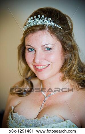 Stock Image - Portrait of young happy bride wearing tiara. Fotosearch