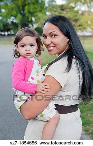 Portrait of young latino mother and daughter in Central Park View Large Photo Image Stock Photograph - Portrait of young latino mother and daughter in Central Park. Fotosearch